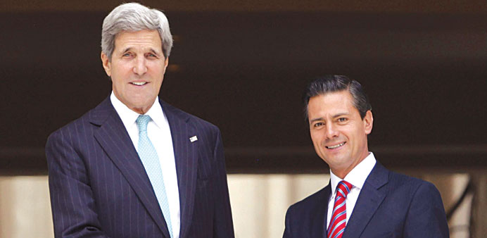 Mexican President Enrique Pena Nieto shakes hands with US Secretary of State John Kerry during a meeting at the Los Pinos residence in Mexico City.