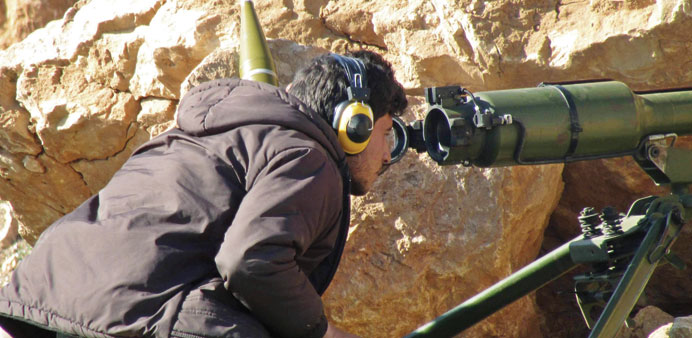A Free Syrian Army fighter looks through a weapon in Sheikh Najjar in Aleppo in this picture taken on Thursday. 