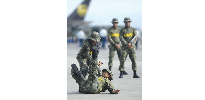 Soldiers show off their CQC (close quarter combat) skills during the Armed Forces of the Philippines (AFP) 80th anniversary celebration.