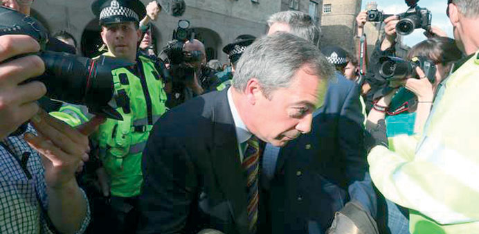Nigel Farage is shielded by police.