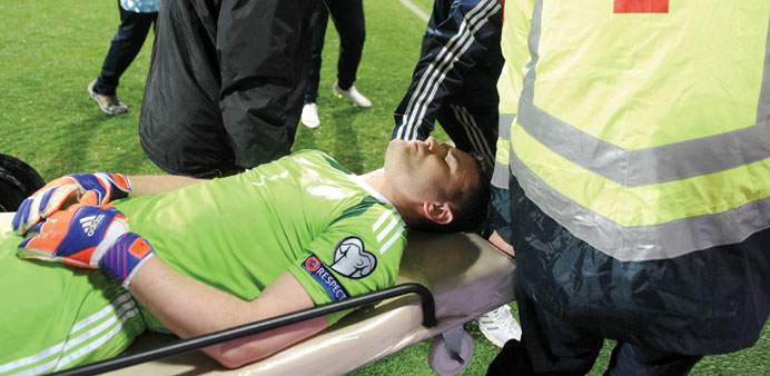 Russia goalkeeper Igor Akinfeev is stretchered off the pitch after he was struck by a flare during the Euro 2016 group G qualifying football match aga