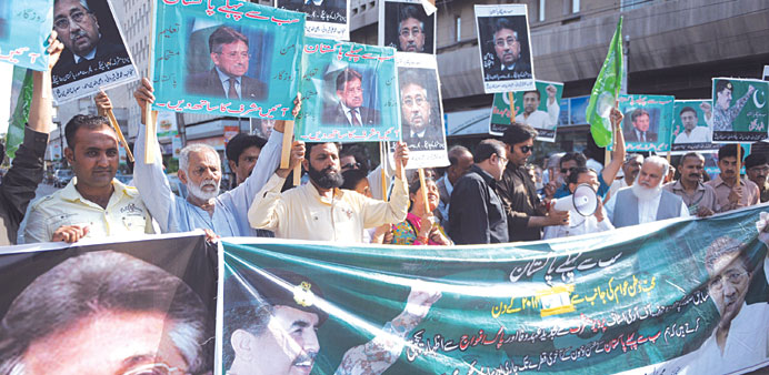 Supporters of Pervez Musharraf shout slogans during a protest in Karachi yesterday.
