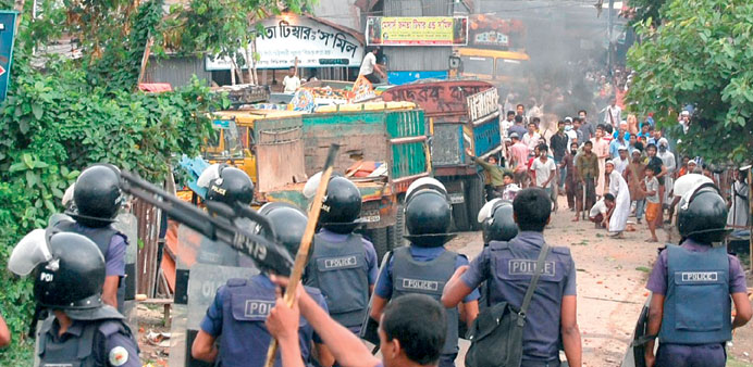 Police fire rubber bullets as Islamist protesters throw bricks and stones at them during clashes in Narayanganj, some 20kms from Dhaka, yesterday.