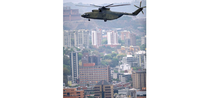 A Russian-made Mi-26 heavy transport helicopter from the Venezuelan Army overflies Caracas yesterday.