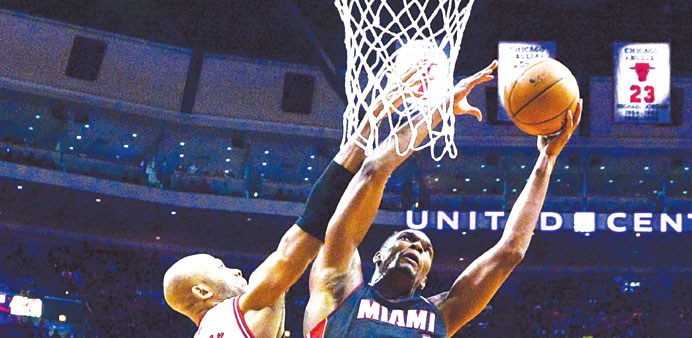 Miami Heat centre Chris Bosh (right) shoots in front of Chicago Bulls forward Taj Gibson in the second half of their NBA game at the United Center in 