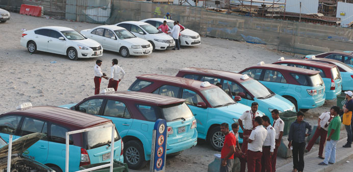Illegal taxis lined up behind the licensed taxis near the Central Bus Station in Doha. PICTURE: Jayan Orma.