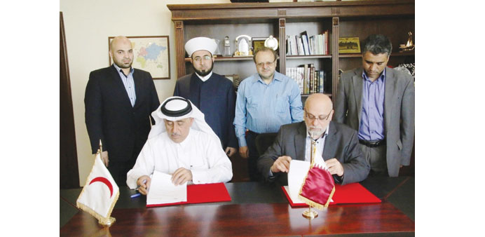 Officials from QRC and Irshad & Islah signing the MoU.